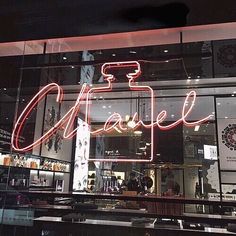 a chanel store front with neon lights