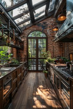 a kitchen with wooden floors and lots of windows on the ceiling is lit by sunlight coming in