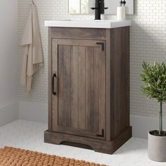 a bathroom with a sink, mirror and rug on the floor in front of it