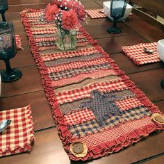 the table is set with red and black checkered placemats, napkins, and flowers