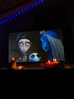 two candles are lit in front of a television screen with corpse from the animated film corpse