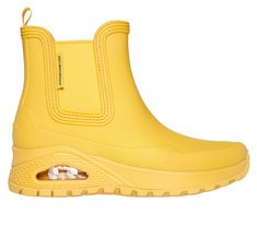 Get iconic style and comfort rain or shine with Skechers Street Uno Rugged - Dancing N The Rain. This fashion rain boot features a waterproof synthetic upper with a cushioned Skechers Air-Cooled Memory Foam insole, and a Skech-Air visible airbag midsole. | Skechers Women's Uno Rugged - Dancing N The Rain Boots | Medium Width | Skechers Air-Cooled Memory Foam cushioned comfort insole | Skech-Air visible airbag midsole | Pull-on synthetic upper | Flexible traction outsole | 1 1/2-inch heel height Yellow Waterproof Rain Boots, Rain Boots Fashion, North And South America, Wide Shoes, Rain Or Shine, Rain Boot, Iconic Style, Skechers Women, 2 Inch Heels