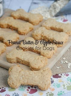 peanut butter and apple sauce cookies for dogs on a cutting board with dog paw prints