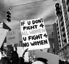 a group of people holding signs in the air