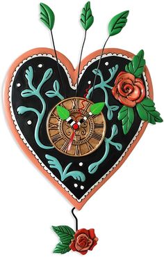 a heart shaped clock with flowers and leaves on it