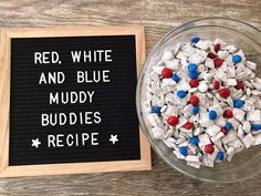 red, white and blue muddy buddies recipe in a glass bowl next to a sign