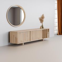 an empty room with a wooden cabinet, mirror and vase on the floor in front of it