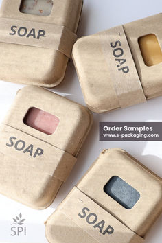 four different soaps are wrapped in brown paper with the words soap and soap on them