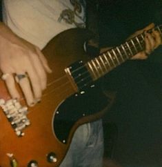 a person playing an electric guitar with their hands