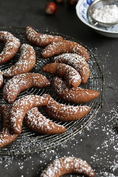 some powdered sugar cookies are on a cooling rack