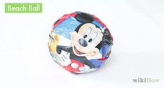 a mickey mouse beach ball sitting on top of a white table