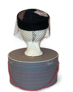 Sixties flat top pillbox hat with black velvet crown and a top with swirls of brown, cream and black topped with a black velvet button and surrounded by birdcage veil. Label: Made in USA Condition is excellent. Measurements Inside circumference: 22 inches, 57 cm Crown height: 2.25 inches, 5.5cm All my items are vintage and may have signs of wear. I try to show any imperfections or damage and the price will reflect them. Yes, I ship internationally. FOR AN ACCURATE SHIPPING QUOTE PLEASE CONTACT M Retro Black Mini Hats For Party, Vintage Cap-shaped Party Fascinator, Black Retro Fascinator For Vintage Events, Vintage Black Cloche Hat For Evening, Vintage Cloche Mini Hat For Evening, Vintage Black Cloche Hat, Black Vintage Cloche Hat, Vintage Black Mini Hat For Vintage Events, Vintage Black Hat For Evening