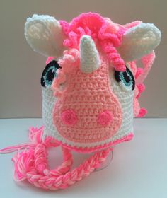 a crocheted cow hat with pink and white trim