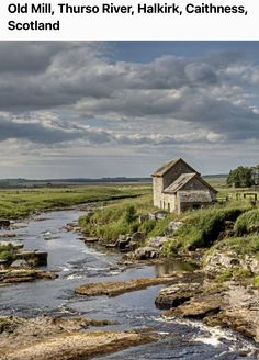 a small house sitting on top of a hill next to a river