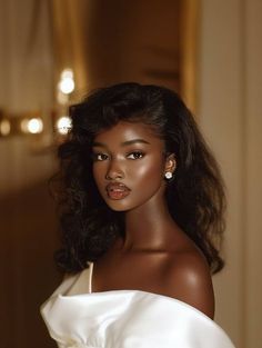 a woman in a white dress posing for the camera with her hair up and eyes closed