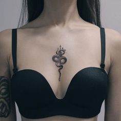 a woman with a snake tattoo on her chest