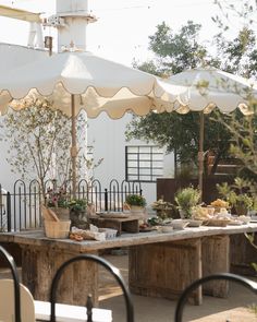 an outdoor dining area with tables and umbrellas