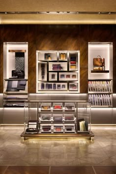 the inside of a book store with many books on shelves and other items in glass cases