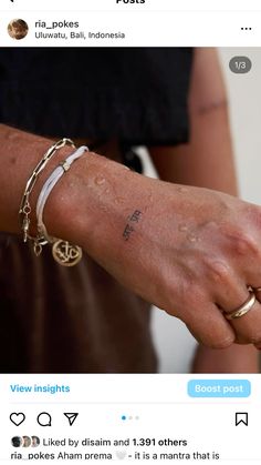 a person holding the arm of another person with tattoos on their arms and wristbands