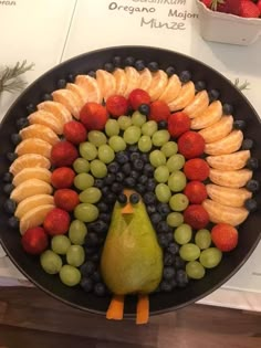 a platter with fruit and vegetables in the shape of a turkey