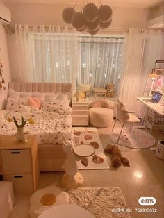 a bedroom with teddy bears on the floor and lights hanging from the ceiling over the bed