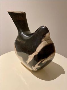 a black and white vase sitting on top of a table