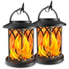 two burning lanterns with flames in them