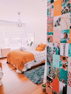 a bed room with a neatly made bed and lots of pictures on the wall