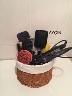 a basket filled with hair brushes and combs sitting on top of a white counter