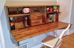 a wooden desk with books and toys on it