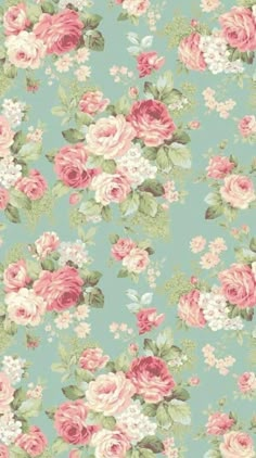 a blue and pink flowered wallpaper with roses in the middle, on top of it