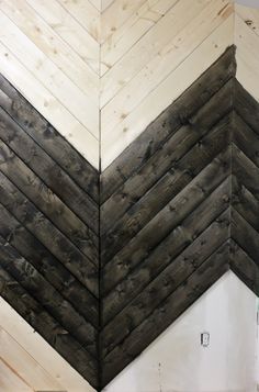 the corner of a wall made out of wood planks