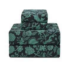 two sheets with blue and green floral designs on them, one is folded over the other