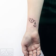 a small tattoo on the wrist of a woman