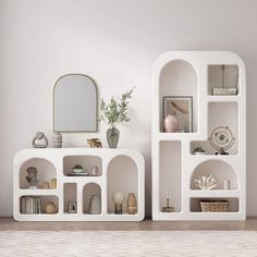 two white shelves with mirrors and vases on them in a room that has tile flooring