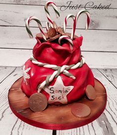 a red cake decorated with candy canes and decorations