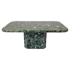 a green marble dining table with square base