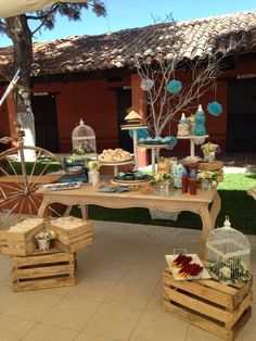 a table that has food on it and some birds in the cage next to it