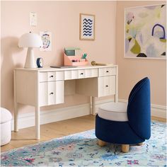 a blue chair sitting in front of a white desk