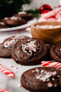 These chocolate peppermint thumbprints feature a thick and rich chocolate cookie filled with chocolate peppermint ganache and crushed candy canes for a festive looking and tasting cookie. | chocolate peppermint thumbprints | chocolate peppermint thumbprint cookies | peppermint chocolate thumbprint | peppermint chocolate cookies | chocolate peppermint cookies | holiday thumbprint cookies | thumbprint cookies recipe | chocolate peppermint cookies recipe