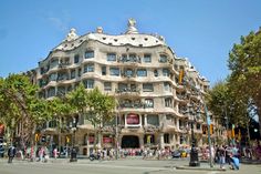 a large building with many windows and balconies on the top of it's sides