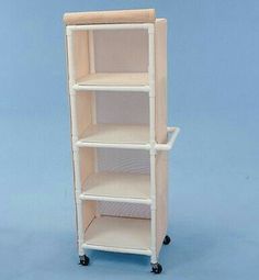 a white shelf with three shelves and wheels on the bottom one is open to show it's contents