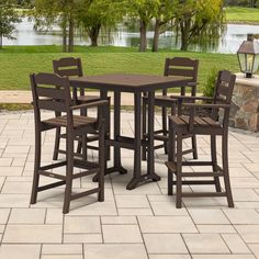 an outdoor table and four chairs on a patio