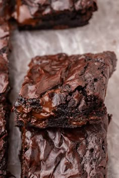 some brownies are cut into squares and stacked on top of each other with chocolate frosting