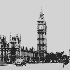 the big ben clock tower towering over the city of london, england in black and white