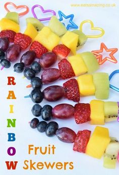 fruit skewers are arranged in the shape of rainbows