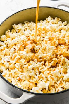 a pot filled with popcorn being poured into it