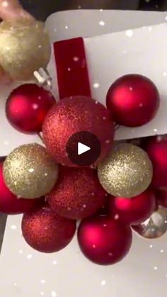 an ornament hanging from a christmas tree with red and gold baubles