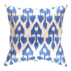 a blue and white pillow on a white background