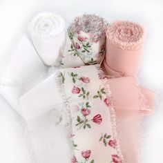 three different types of cloths on top of each other, one pink and one white